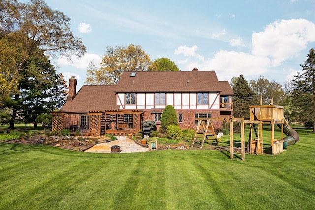 3603 Creekside Dr, Ann Arbor, MI 48105 - back of property featuring a yard, a patio area, a playground, and a chimney