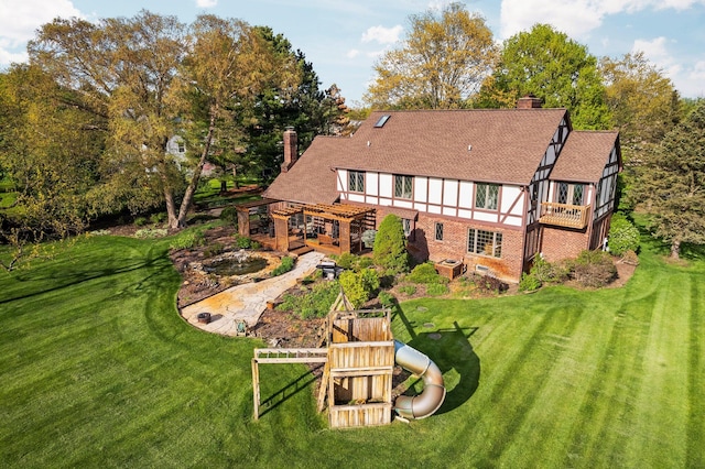3603 Creekside Dr, Ann Arbor, MI 48105 - rear view of house featuring a wooden deck, a chimney, and a lawn