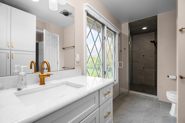 3603 Creekside Dr, Ann Arbor, MI 48105 - bathroom with baseboards, vanity, toilet, and a stall shower
