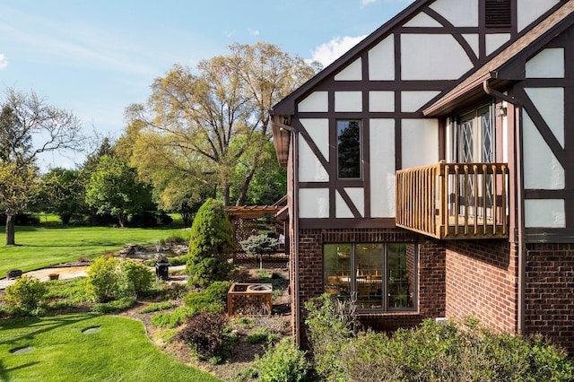 3603 Creekside Dr, Ann Arbor, MI 48105 - exterior space featuring a yard, stucco siding, brick siding, and a balcony