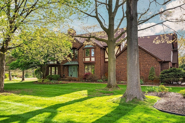 3603 Creekside Dr, Ann Arbor, MI 48105 - view of front facade with a front lawn, brick siding, and a chimney