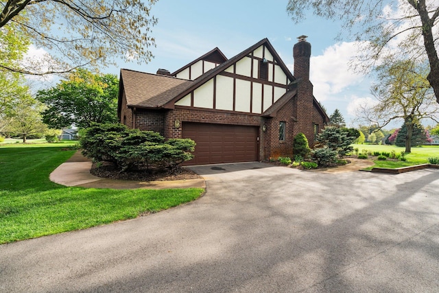 3603 Creekside Dr, Ann Arbor, MI 48105 - view of side of property with brick siding, driveway, a chimney, and a lawn