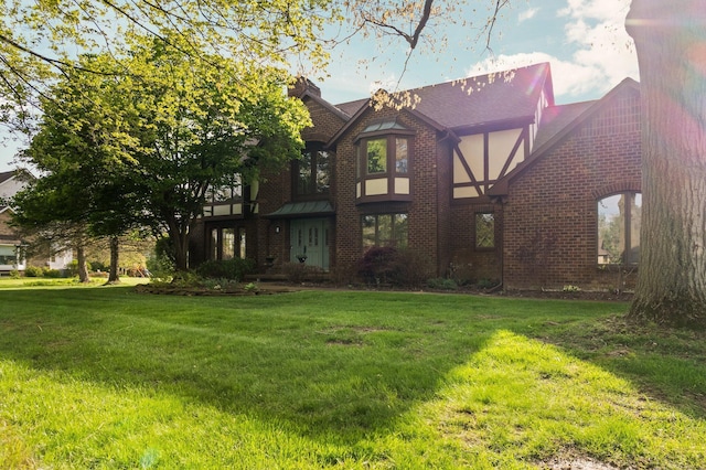 3603 Creekside Dr, Ann Arbor, MI 48105 - rear view of property with a yard, a chimney, and brick siding