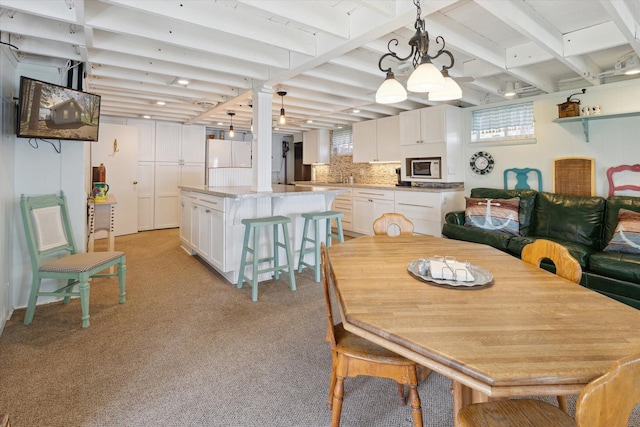 10458 Sleepy Hollow Ln, Mecosta, MI 49332 - dining room with light carpet and beam ceiling