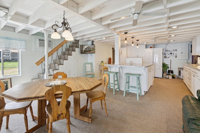 10458 Sleepy Hollow Ln, Mecosta, MI 49332 - dining space with light colored carpet, beamed ceiling, stairway, and a ceiling fan