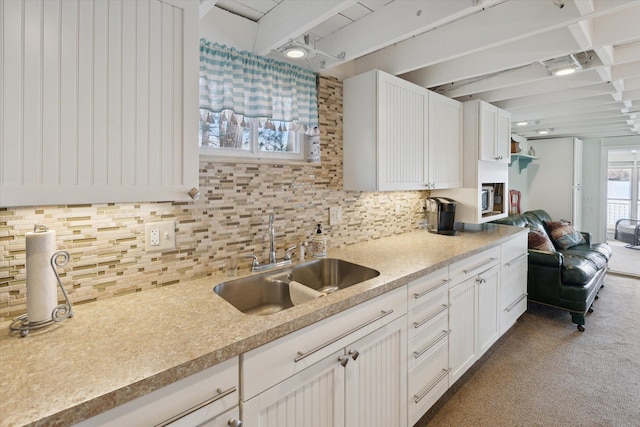 10458 Sleepy Hollow Ln, Mecosta, MI 49332 - kitchen with a sink, decorative backsplash, white cabinetry, and light countertops