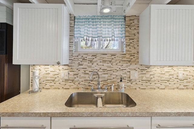 10458 Sleepy Hollow Ln, Mecosta, MI 49332 - kitchen featuring a sink, white cabinetry, and backsplash