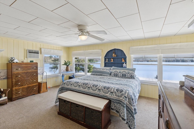 10458 Sleepy Hollow Ln, Mecosta, MI 49332 - carpeted bedroom featuring wooden walls, ceiling fan, an AC wall unit, and a water view
