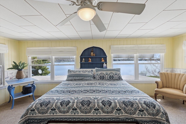 10458 Sleepy Hollow Ln, Mecosta, MI 49332 - carpeted bedroom with multiple windows and wooden walls