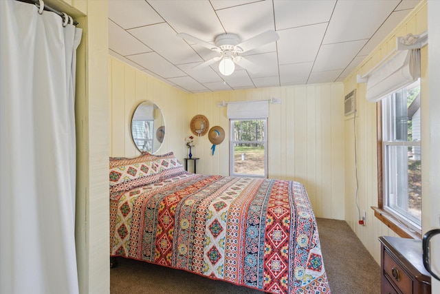 10458 Sleepy Hollow Ln, Mecosta, MI 49332 - carpeted bedroom featuring ceiling fan, wood walls, and a wall mounted air conditioner