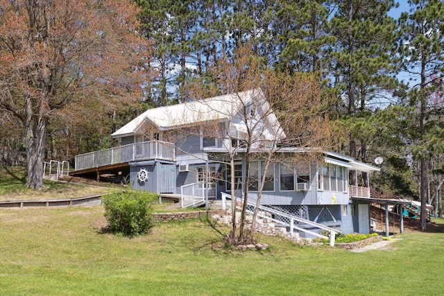 10458 Sleepy Hollow Ln, Mecosta, MI 49332 - rear view of property featuring a lawn, a deck, stairs, and a sunroom