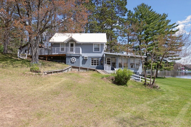 10458 Sleepy Hollow Ln, Mecosta, MI 49332 - back of property featuring a deck with water view, a sunroom, and a lawn