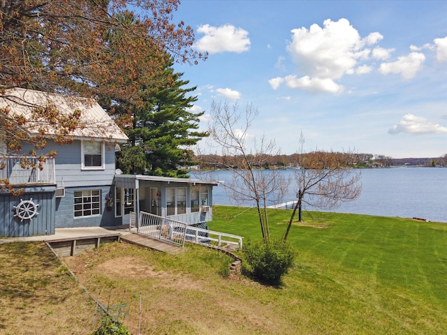 10458 Sleepy Hollow Ln, Mecosta, MI 49332 - view of green lawn featuring a sunroom and a water view