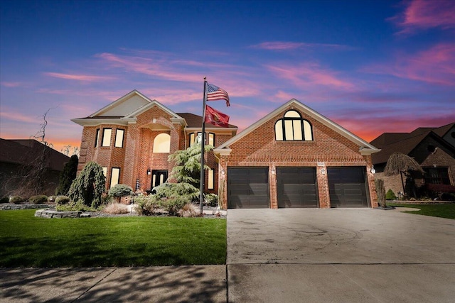 traditional home featuring brick siding, driveway, a lawn, and a garage