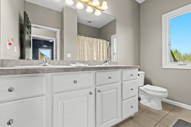 bathroom featuring a shower with curtain, toilet, baseboards, tile patterned floors, and vanity