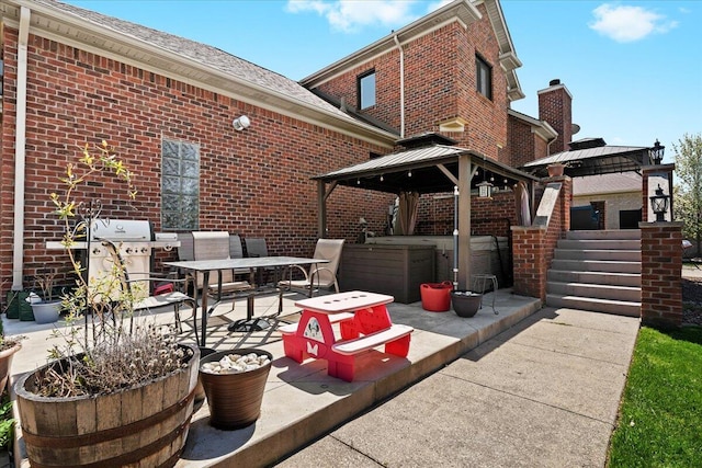 view of patio / terrace featuring a gazebo, outdoor dining area, a jacuzzi, and grilling area