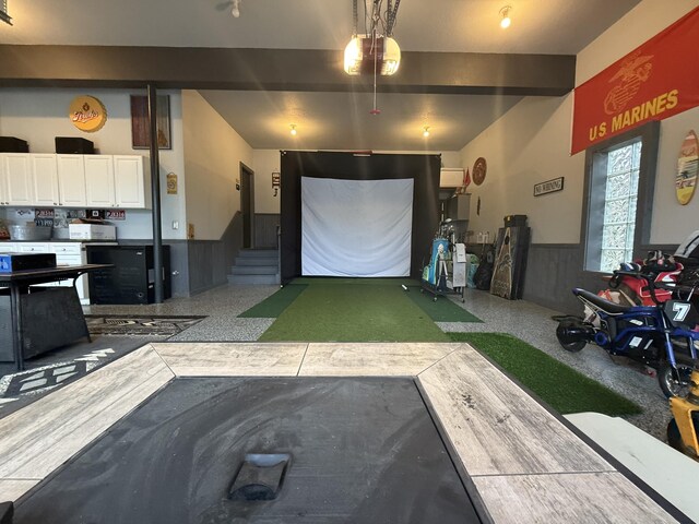 garage featuring a wainscoted wall and a garage door opener