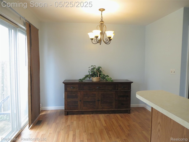 37800 Charter Oaks Blvd, Clinton Township, MI 48036 - dining area with light wood-type flooring, a chandelier, and baseboards