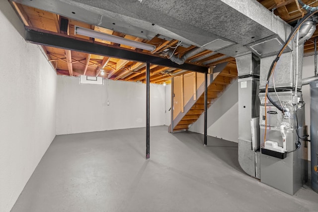 below grade area with stairway and heating unit