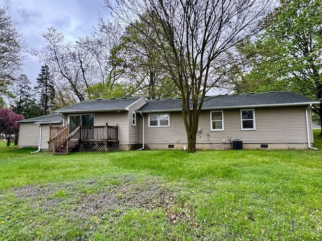 rear view of house with a yard, crawl space, and a wooden deck