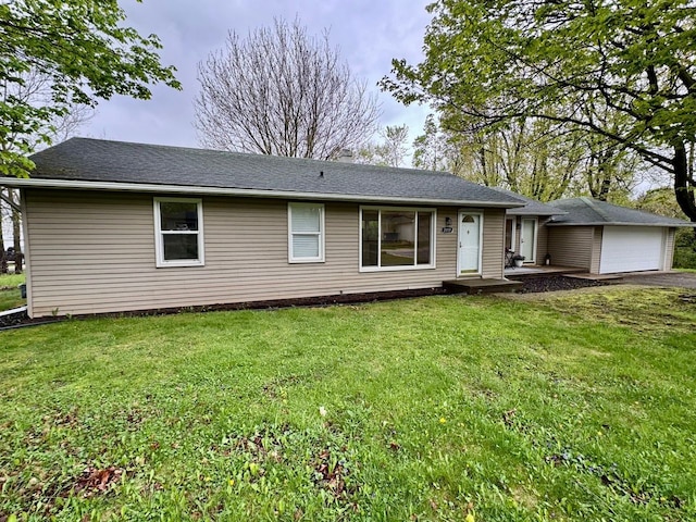 ranch-style home featuring driveway, a front lawn, and a garage