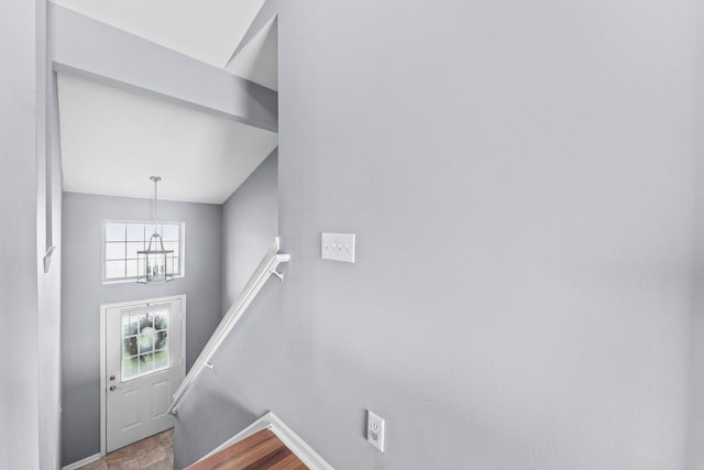 foyer entrance with baseboards and an inviting chandelier