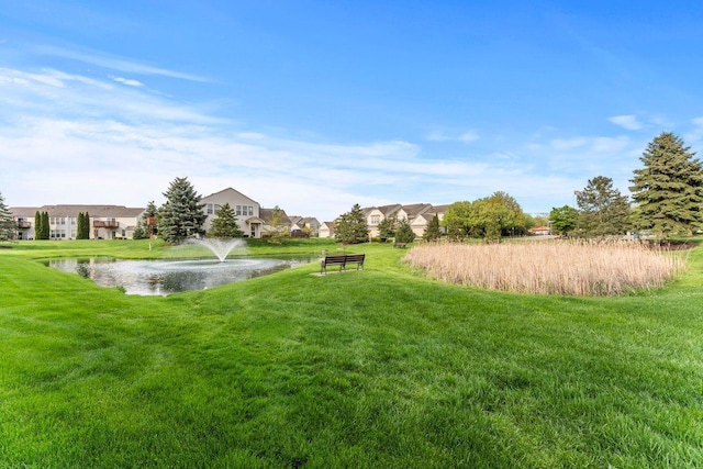 view of yard with a water view and a residential view