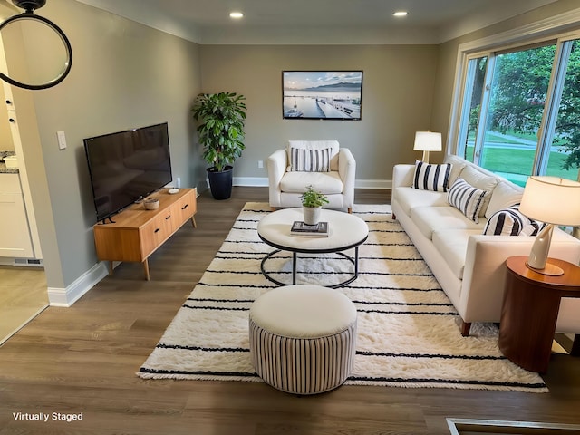 living area featuring wood finished floors, baseboards, and recessed lighting
