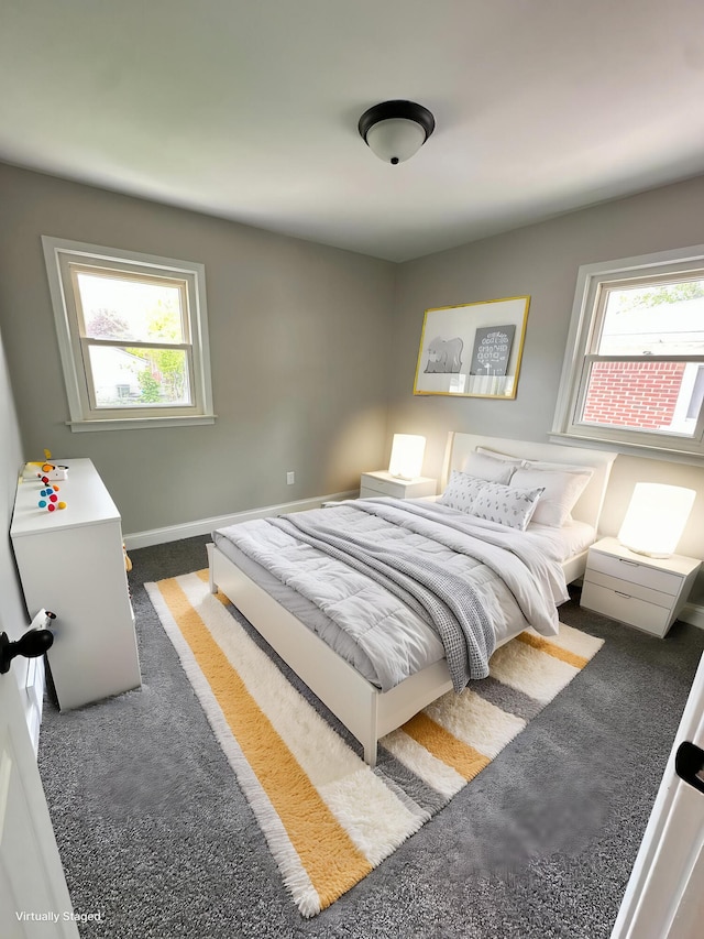 bedroom featuring baseboards, multiple windows, and carpet floors