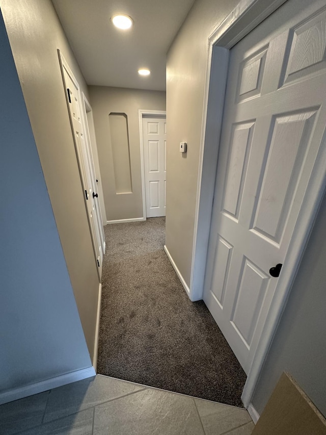 hall with carpet flooring, baseboards, and recessed lighting