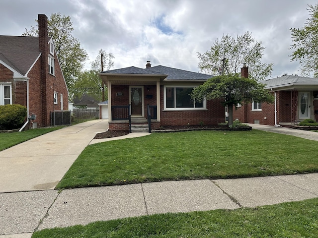 view of front of house featuring a chimney, brick siding, and a front yard