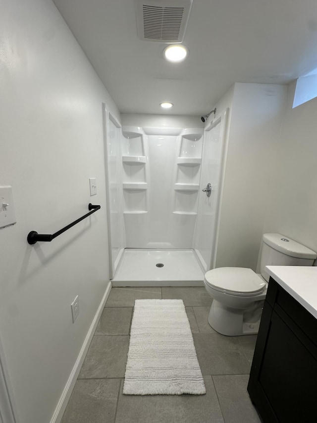 bathroom featuring toilet, vanity, visible vents, tile patterned floors, and a shower stall