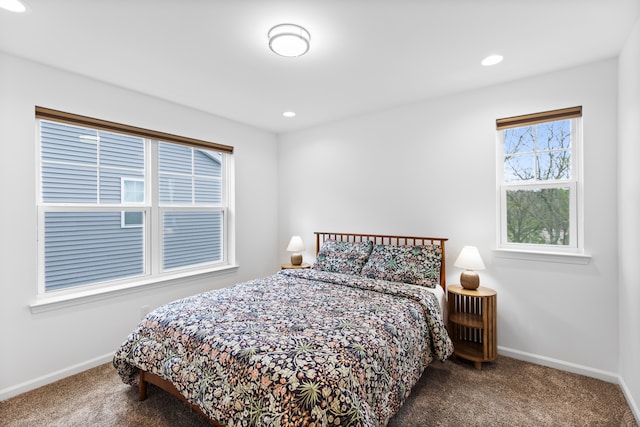 carpeted bedroom featuring baseboards and recessed lighting
