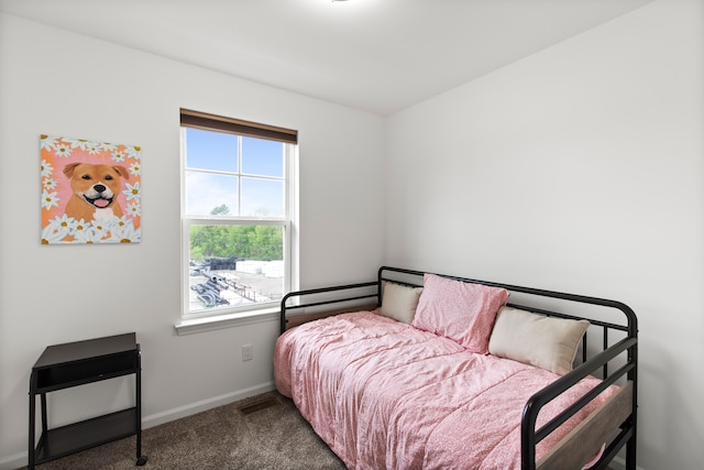 bedroom with carpet floors and baseboards