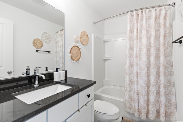 bathroom featuring toilet, shower / tub combo, and vanity
