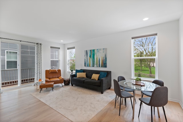 living room with light wood finished floors, recessed lighting, and baseboards