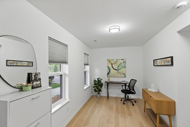 office space featuring light wood-type flooring and baseboards