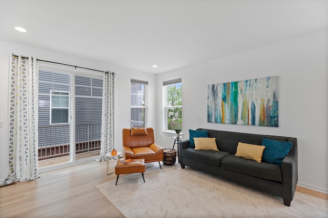 living room featuring wood finished floors, recessed lighting, and baseboards