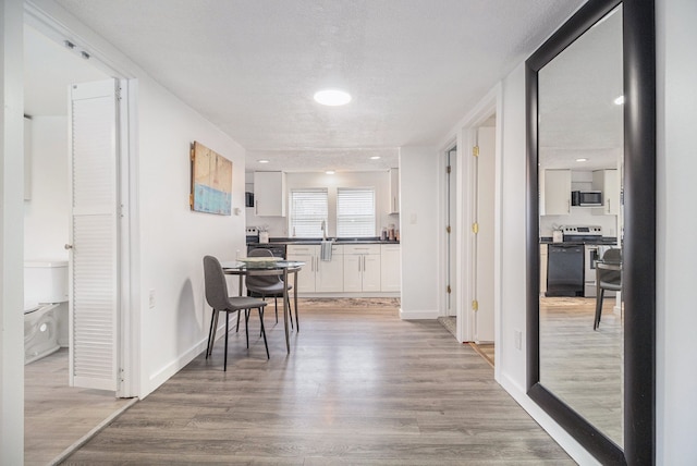 3012 Lansdowne Rd, Waterford, MI 48329 - dining room featuring light wood-style floors and baseboards