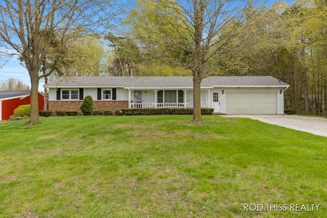 single story home with a porch, an attached garage, brick siding, driveway, and a front yard