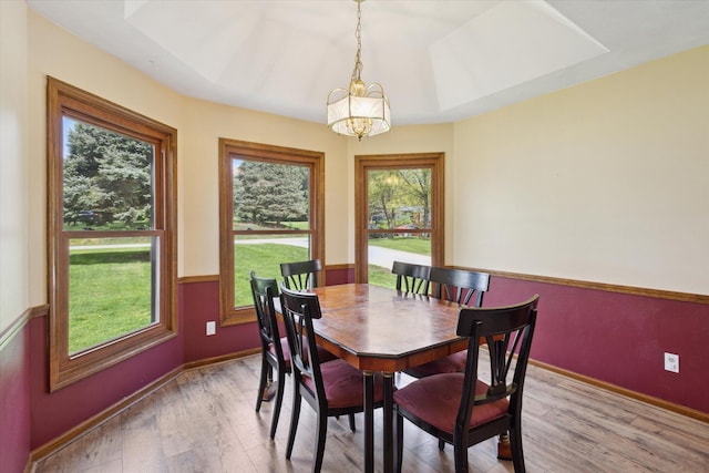 11104 Southbrook Dr, Ceresco, MI 49033 - dining area featuring a chandelier, light wood-style flooring, and baseboards