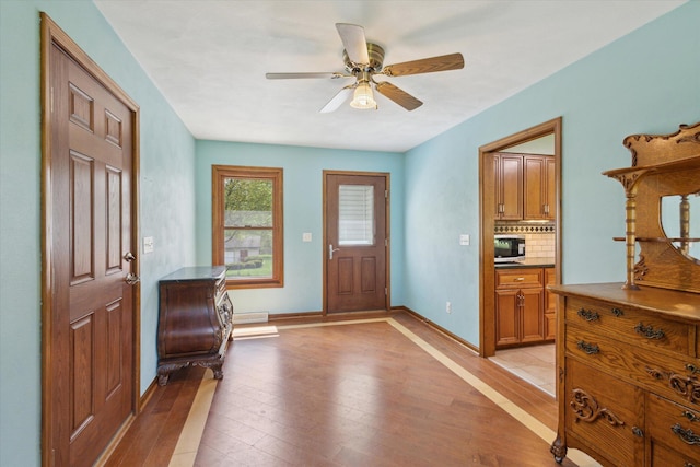 11104 Southbrook Dr, Ceresco, MI 49033 - entryway with light wood finished floors, a ceiling fan, and baseboards