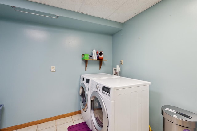 11104 Southbrook Dr, Ceresco, MI 49033 - laundry area featuring separate washer and dryer, light tile patterned floors, and baseboards