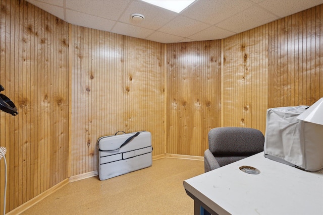 11104 Southbrook Dr, Ceresco, MI 49033 - home office featuring a paneled ceiling, wooden walls, carpet floors, and baseboards