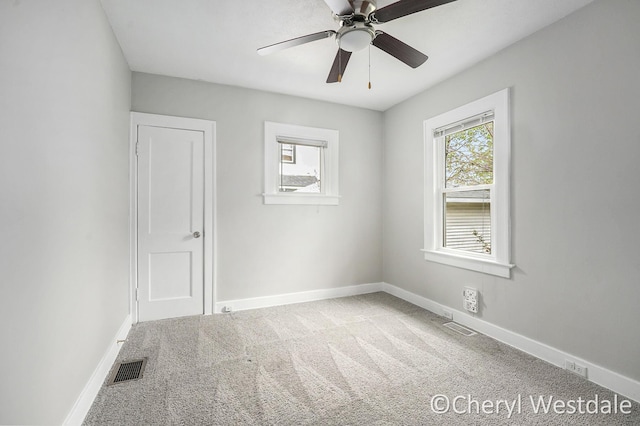 unfurnished room featuring baseboards, carpet flooring, and visible vents