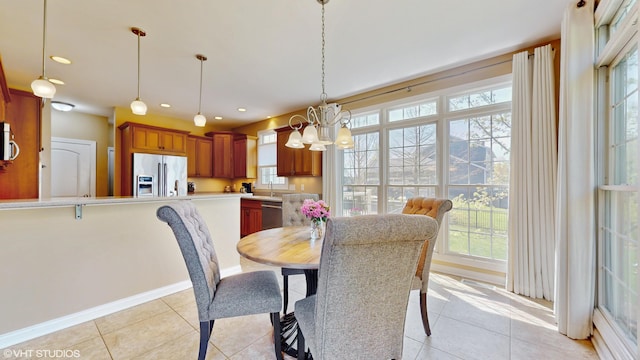 7272 Holden Rd, Stevensville, MI 49127 - dining space featuring baseboards, a healthy amount of sunlight, a chandelier, and light tile patterned flooring