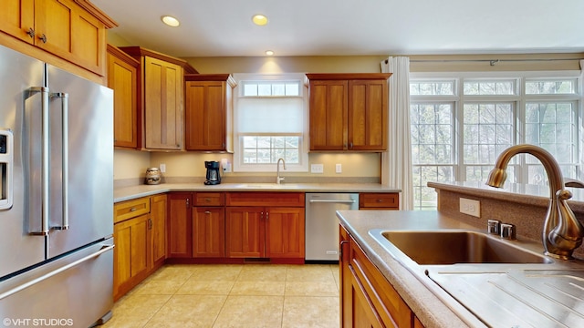 7272 Holden Rd, Stevensville, MI 49127 - kitchen featuring a sink, brown cabinetry, stainless steel appliances, and light countertops