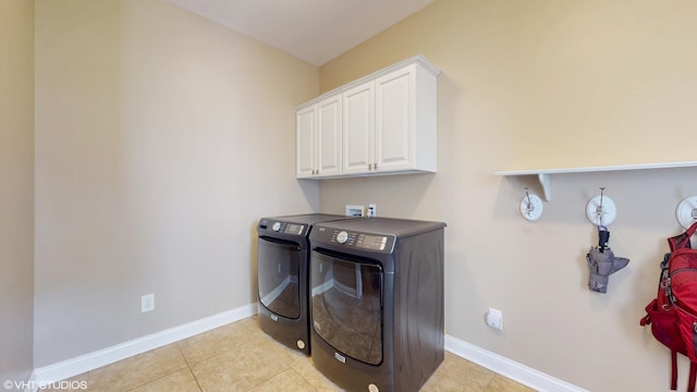 7272 Holden Rd, Stevensville, MI 49127 - laundry room with baseboards, washing machine and dryer, light tile patterned floors, and cabinet space