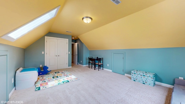 7272 Holden Rd, Stevensville, MI 49127 - playroom featuring vaulted ceiling with skylight, carpet, baseboards, and visible vents