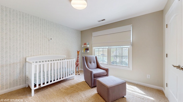 7272 Holden Rd, Stevensville, MI 49127 - bedroom featuring wallpapered walls, carpet floors, visible vents, baseboards, and an accent wall